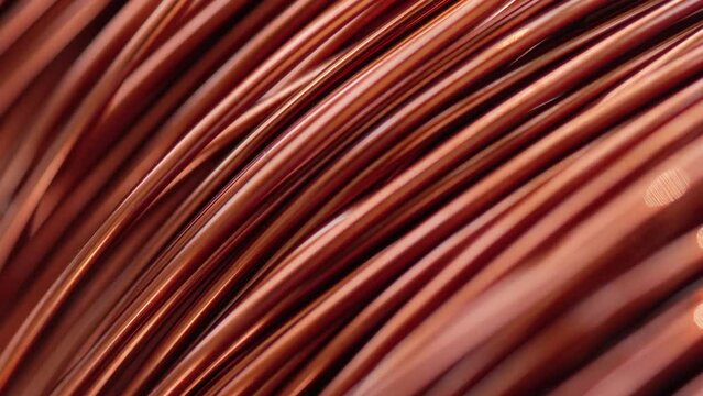Close up of the bare bright copper wire on the spool, Rack focus
