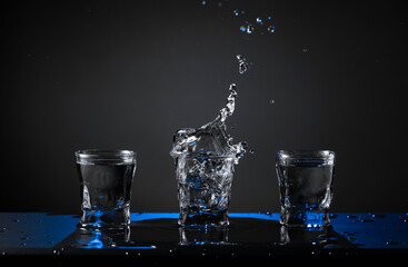 Alcoholic shots of vodka or strong drink in small glasses.