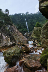 Cascading Waterfall Amidst Rocky Surroundings