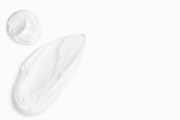 cream smears on a light background. Empty space