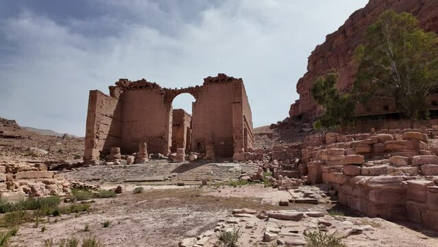 Temple of Dushares with crumbling sandstone walls and columns are all that remain of the monumental gateway to the sacred precinct of Qasr Al Bint in Petra, Jordan