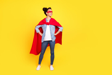 Full body portrait of nice young girl look empty space superhero costume isolated on yellow color background