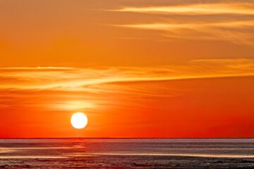 Vibrant orange sunset over calm ocean horizon