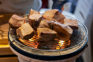 Chef cooking a sous vide beef tongue on fire.