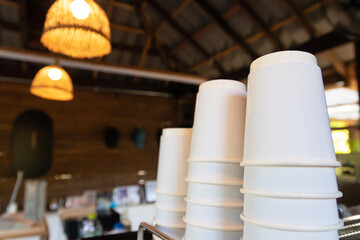 Stack of paper cup for hot drink in a cafe.