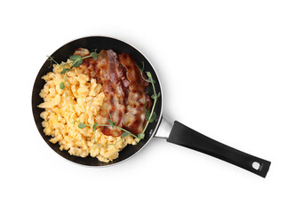 Delicious scrambled eggs with bacon in frying pan isolated on white, top view
