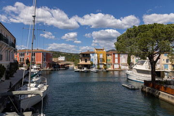 Fototapeta premium Downtown of Port Grimaud in France with cafes, restaurants, yachts and sailboats in spring