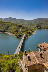 A view of Lake Turano, from the village of Castel di Tora, Rieti, Lazio, Italy. The bridge crossing...