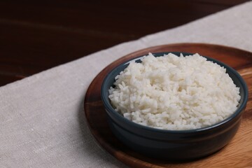 Delicious boiled rice served on table. Space for text