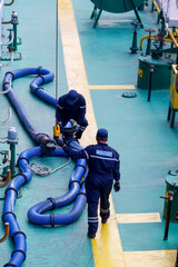 Ship refueling operation in port.