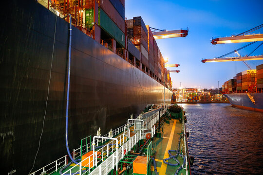 Ship refueling operation in port.