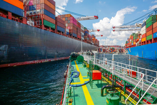Ship refueling operation in port.