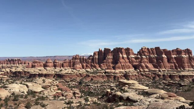 A stunning view of the rock formations in Canyonlands National Park, Utah. The Needles district features a rugged landscape of canyons and sandstone spires. The La Sal Mountains in background - USA