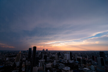 Obraz premium Sunset in megalopolis. Beautiful cityscape with top view on skyscrapers. Bangkok, Thailand.