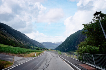 Asphalt road in Alp mountains. Road trip concept. Beautiful landscape.