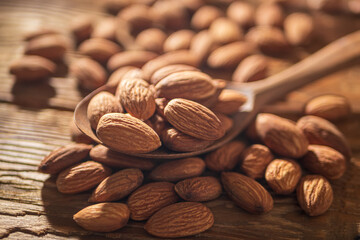 Almond in Wooden Spoon on a Rustic Table. Food Concept of Healthy Eating. Delicious Roasted Almond Nut, Vegan Food