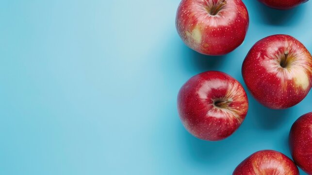 Concept of eco friendly fruits Fresh organic red apples on blue backdrop Emphasis on sustainability healthy produce Aerial perspective with space for text Eco conscious approach to reduce wa