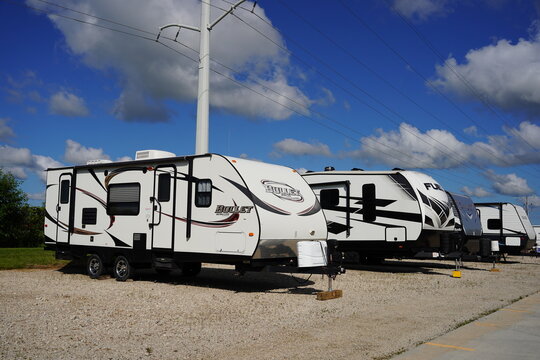 Fuel, Springdale, Guide, and many other brands of 5th Wheel campers sit stored at a storage site.