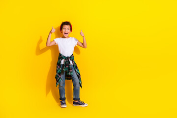 Full length photo of adorable little boy thumb up excited dressed stylish white garment isolated on yellow color background