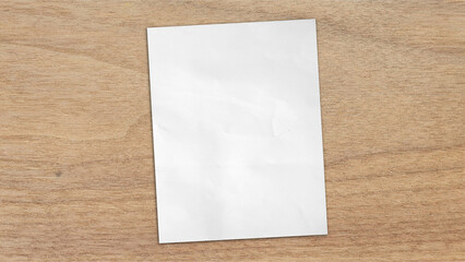 empty blank white grunge paper sheet placed on light oak wooden table counter, top view. sheet of blank note paper with blank space for design.