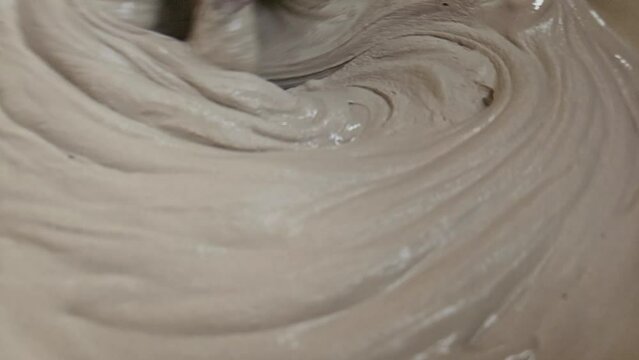 Hand Of An Sculpture Artist Mixing Plaster Of Paris And Water In A Bowl To Make Plaster Mold, India