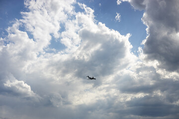 Passenger airplane flying in the sky amazing clouds in the background. Travel by air transport.