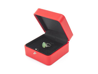 Red gift case with silver ring with gemstone on white background