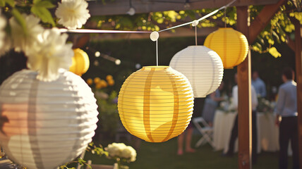 Fototapeta premium Garden party in the summer. Beautiful and cute paper lanterns blowing in wind and getting bright, Summer festival Summer vacation. Family garden party on sunny day