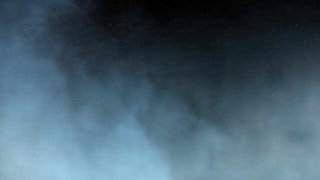 Blue Smoke and Ash Rolling 4K Loop features blue hued smoke and ash or snow rolling from left to right against a black background in a loop.