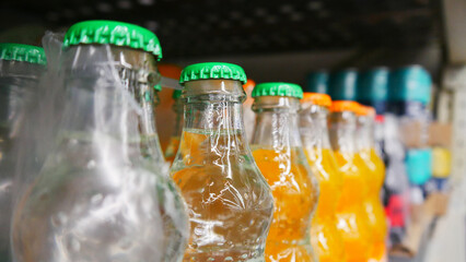 Close-up of many glass soda bottles on a retail display