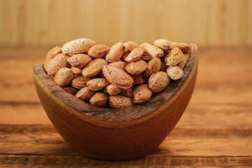 Almond in Shell in Wooden Bowl on a Rustic Table. Food Concept of Healthy Eating. Delicious Almond Nut, Vegan Food