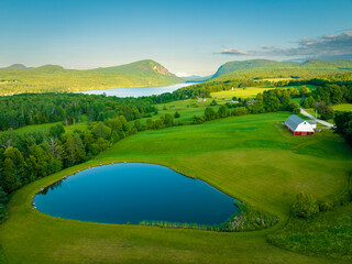 Overlooking Vermont Farm with pond and red barn © John