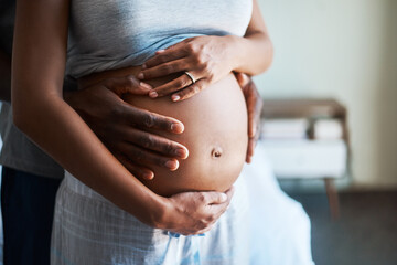 Couple, hands and stomach with pregnancy for maternity, love or care in support, health and wellness at home. Closeup of man holding baby bump, belly or tummy of pregnant woman for expectation