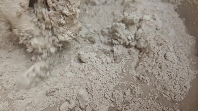 Clay Artist Mixing Plaster Of Paris And Water In A Bowl To Make Plaster Mold, India