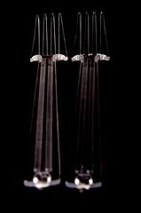 two fors plastic on black background