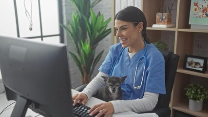 A hispanic woman veterinarian with a chihuahua dog conducts a telehealth consultation in a clinic office.