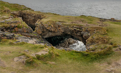 Blow hole creating a fairy bridge on a cliff