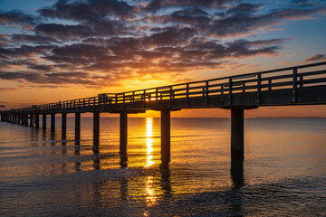 Fototapeta premium Fantastically beautiful sunrise on the pier in Boltenhagen on the Baltic Sea