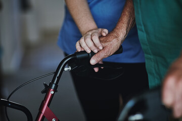 Hands, assistance and elderly man in nursing home for support, healthcare and wellness. Physiotherapy, balance and rehabilitation for person with disability and osteoporosis treatment in lounge