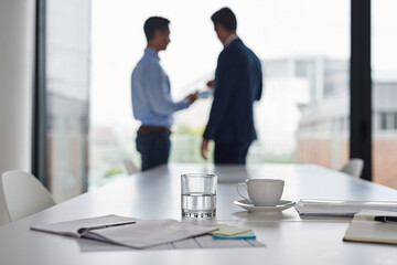 Meeting, notebook and business people in boardroom for discussion, risk assessment or compliance. Corporate, legal advisor and client with table for conversation, collaboration or briefing in office