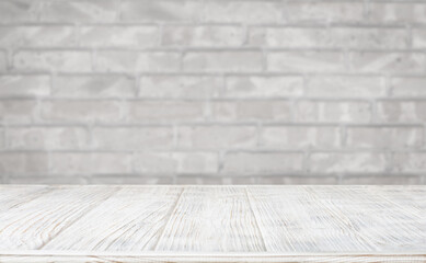 White wooden table against grey brick wall for product showcase