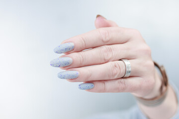 beautiful female hands with long nails light gray manicure