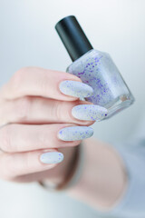 beautiful female hands with long nails light gray manicure