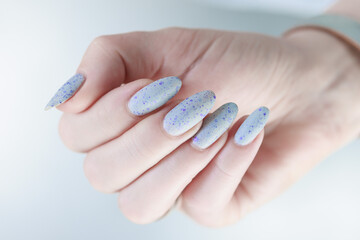 beautiful female hands with long nails light gray manicure