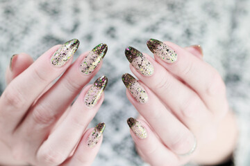 Woman's hands with long nails and white and black thermo