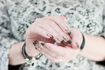 Woman's hands with long nails and white and black thermo french manicure	