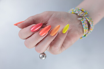 Woman hand with long nails and multi-colored manicure, red, orange and yellow nail polish  © Tatiana
