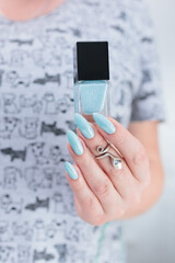 Female hand with long nails and light blue manicure