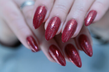 Female hands with long nails and dark red nail polish