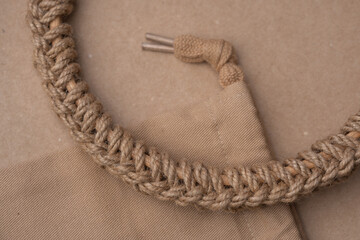 Woven craft rope.Beige fabric bag. The natural textures and earthy tones create a rustic and eco-friendly aesthetic, perfect for sustainable fashion, craft projects, and organic design elements.